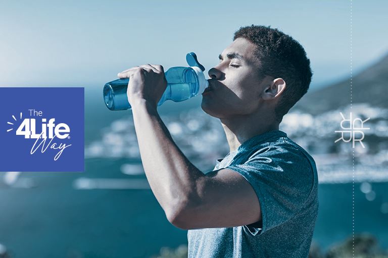 Man drinking from a water bottle on a sunny day, staying hydrated.