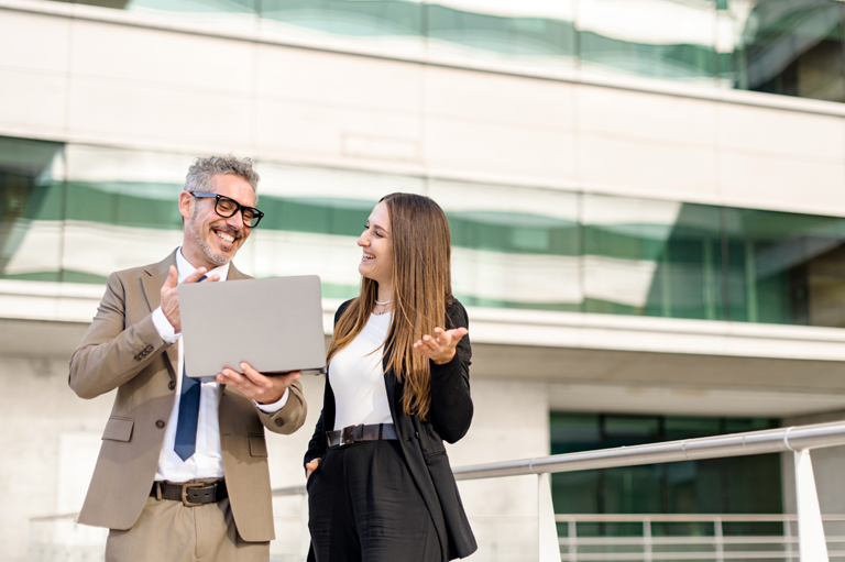 two person working together smiling relationship economy