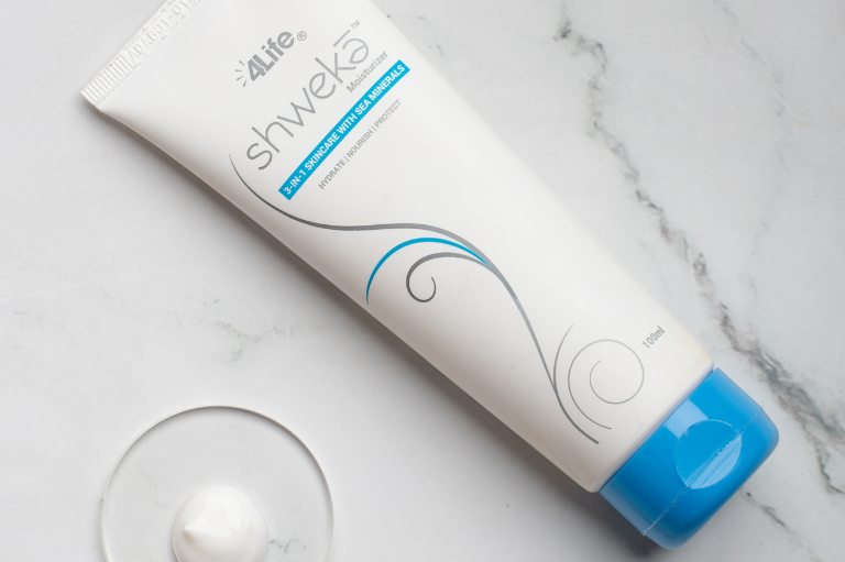 Close-up of 4Life India Shweka Moisturizer with drop showing smooth consistency on white background