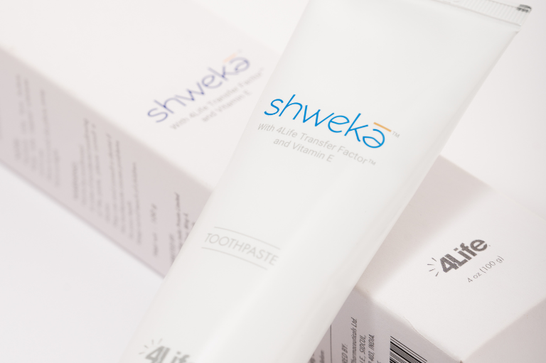 Close-up of Shweka Toothpaste tube featuring Transfer Factors and natural oral care branding
