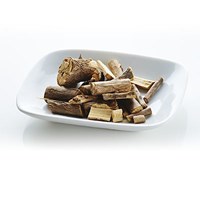 Dried, woody Eleuthero root on a white plate, an adaptogen that may reduce fatigue and support brain blood circulation.